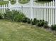 Well-maintained lawn with decorative plants lining a classic white picket fence at 6836 Eagle Crossing Blvd, Brownsburg, IN 46112