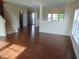 A well-lit living room shows an open floor plan with hardwood floors at 6836 Eagle Crossing Blvd, Brownsburg, IN 46112
