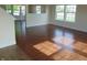 A photo highlighting the beautiful wood flooring in a well-lit living room with multiple windows at 6836 Eagle Crossing Blvd, Brownsburg, IN 46112