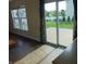 View of back patio through sliding glass doors with view of lawn and white picket fence at 6836 Eagle Crossing Blvd, Brownsburg, IN 46112