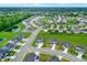 Community aerial view featuring contemporary homes, green spaces and a serene neighborhood pond at 6843 Black Cherry Ter, Brownsburg, IN 46112
