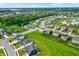 Community aerial showcasing modern homes with lush lawns and ponds, creating a tranquil neighborhood at 6843 Black Cherry Ter, Brownsburg, IN 46112