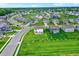 Aerial shot of a neighborhood featuring houses with well-kept lawns and professionally landscaped spaces at 6843 Black Cherry Ter, Brownsburg, IN 46112