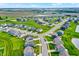 An aerial view of a residential neighborhood with a pond and green spaces surrounded by modern homes and connecting roads at 6843 Black Cherry Ter, Brownsburg, IN 46112
