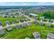 Aerial view of a suburban community, showcasing modern homes, ponds, and green landscapes at 6843 Black Cherry Ter, Brownsburg, IN 46112