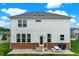 View of the backyard with brick foundation, patio, and gray siding at 6843 Black Cherry Ter, Brownsburg, IN 46112