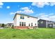 Expansive backyard featuring a well-manicured lawn, patio, and two-story home exterior at 6843 Black Cherry Ter, Brownsburg, IN 46112