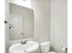 Clean and simple powder room with a white sink, toilet, and a large mirror at 6843 Black Cherry Ter, Brownsburg, IN 46112