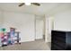 Bright bedroom with a ceiling fan, neutral carpet, and a toy house at 6843 Black Cherry Ter, Brownsburg, IN 46112