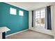 Cozy bedroom with carpet, a window with gray curtains, and a built-in desk, creating a comfortable and functional space at 6843 Black Cherry Ter, Brownsburg, IN 46112