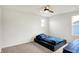 Bright bedroom with ceiling fan, small window, and bed with a blue Spiderman-themed comforter at 6843 Black Cherry Ter, Brownsburg, IN 46112