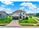 Aerial view of a charming two-story home with a dark two-car garage and well-maintained lawn at 6843 Black Cherry Ter, Brownsburg, IN 46112