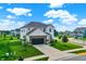 Aerial view of a beautifully landscaped two-story home featuring a two-car garage and lush green lawn at 6843 Black Cherry Ter, Brownsburg, IN 46112