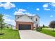 Attractive two-story home with brick accents, a spacious driveway, and a well-kept lawn on a sunny day at 6843 Black Cherry Ter, Brownsburg, IN 46112