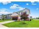Beautiful two-story home boasting a well-maintained lawn, brick accents, and a tree-lined yard on a bright, sunny day at 6843 Black Cherry Ter, Brownsburg, IN 46112