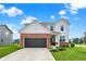 Charming two-story home featuring a brick and white exterior with a well-manicured lawn and attached two-car garage at 6843 Black Cherry Ter, Brownsburg, IN 46112