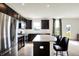 Well-lit kitchen with stainless steel appliances, an island with seating, and lots of natural light from the window at 6843 Black Cherry Ter, Brownsburg, IN 46112