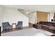 Spacious living room featuring hardwood floors, a staircase, and comfortable seating arrangements with neutral decor at 6843 Black Cherry Ter, Brownsburg, IN 46112