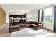 Open-concept living room with hardwood floors, a comfortable sectional sofa, and a seamless view of the kitchen at 6843 Black Cherry Ter, Brownsburg, IN 46112