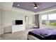 Bright main bedroom features tray ceiling, ceiling fan, and abundant natural light from large window at 6843 Black Cherry Ter, Brownsburg, IN 46112