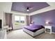 Stylish main bedroom with a tray ceiling, a large window, and elegant bedside tables at 6843 Black Cherry Ter, Brownsburg, IN 46112
