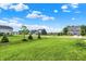 Street view of new homes on large grassy lots, creating a picturesque neighborhood setting on a beautiful day at 6843 Black Cherry Ter, Brownsburg, IN 46112