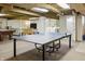 Finished basement with a ping pong table, pool table and laundry area at 7060 N Park Ave, Indianapolis, IN 46220