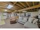 Finished basement with an exposed ceiling, seating, and rec area at 7060 N Park Ave, Indianapolis, IN 46220