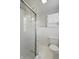 Clean bathroom featuring a glass block shower, white toilet, and vanity cabinet at 7060 N Park Ave, Indianapolis, IN 46220