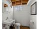 Basement bathroom featuring classic fixtures, painted cinder block and unique mirror at 7060 N Park Ave, Indianapolis, IN 46220