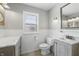 Charming bathroom features a large mirror, natural light, and modern vanity with storage at 7060 N Park Ave, Indianapolis, IN 46220