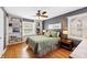 Bright bedroom features hardwood floors, stylish decor, built-in shelving, and a comfortable bed at 7060 N Park Ave, Indianapolis, IN 46220