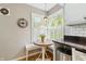 Charming breakfast nook area features a round table, built-in bench, and a large bright window at 7060 N Park Ave, Indianapolis, IN 46220