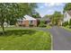 Charming brick home with a well-manicured lawn and a long, curved driveway at 7060 N Park Ave, Indianapolis, IN 46220