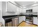 Bright kitchen featuring stainless steel appliances, granite countertops, and white cabinets and subway tile backsplash at 7060 N Park Ave, Indianapolis, IN 46220
