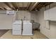 Well-lit laundry area with washer, dryer, utility sink, and storage at 7060 N Park Ave, Indianapolis, IN 46220