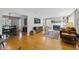 Open-concept living room with hardwood floors, fireplace, and abundant natural light at 7060 N Park Ave, Indianapolis, IN 46220