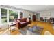Comfortable living room with hardwood floors, large window, and ample seating at 7060 N Park Ave, Indianapolis, IN 46220