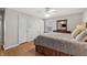 Comfortable main bedroom features hardwood floors, ceiling fan, and ample storage space at 7060 N Park Ave, Indianapolis, IN 46220