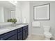 Modern bathroom featuring double sinks, granite countertops, and ample lighting at 7239 Barrett Dr, Brownsburg, IN 46112
