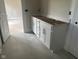 Bathroom featuring a double vanity with white cabinets, tile floors, and neutral paint at 7239 Barrett Dr, Brownsburg, IN 46112