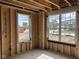 Unfinished room with two large windows and view of neighborhood homes under construction at 7239 Barrett Dr, Brownsburg, IN 46112