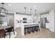 Modern kitchen features a large island, stainless steel appliances, and sleek, white cabinets at 7239 Barrett Dr, Brownsburg, IN 46112