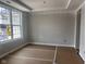 Bright living room featuring large window, neutral walls, and temporary floor protection at 7239 Barrett Dr, Brownsburg, IN 46112