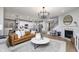 Open-concept living area showcases a fireplace, hardwood floors, and seamless flow to the kitchen at 7239 Barrett Dr, Brownsburg, IN 46112
