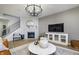 Bright living room features hardwood floors, a fireplace, and a stylish chandelier at 7239 Barrett Dr, Brownsburg, IN 46112