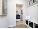Functional mud room with bench seating and storage leading to a laundry room at 7239 Barrett Dr, Brownsburg, IN 46112