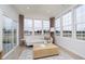 Relaxing sunroom bathed in natural light features a comfortable sofa and serene views of the outdoors at 7239 Barrett Dr, Brownsburg, IN 46112