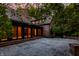 Large stone patio with a brick wall and multiple glass doors leading inside at 7406 N Washington Blvd, Indianapolis, IN 46240