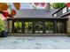 Charming brick home featuring a serene stone patio and glass-enclosed porch, seamlessly blending indoor and outdoor living at 7406 N Washington Blvd, Indianapolis, IN 46240